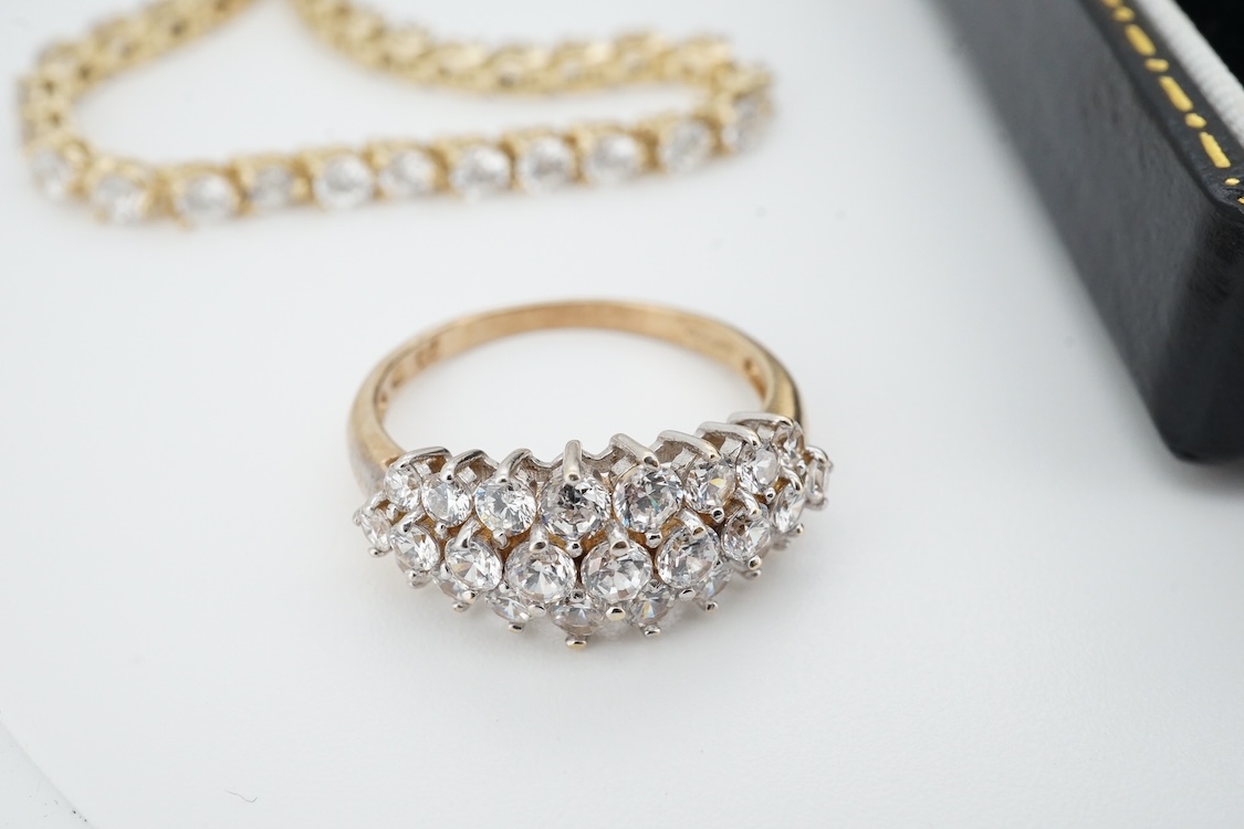 A modern yellow metal (stamped 585) and cubic zirconia set line bracelet, 18cm and a pair of similar drop earrings, together with a similar 9k and cubic zirconia set cluster ring, size N.